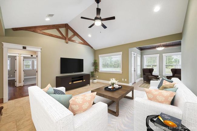 WELCOME INTO THIS SPACIOUS FAMILY ROOM THAT FLOWS EFFORTLESSLY INTO AN OPEN FLOORPLAN. HIGH CEILINGS ADORNED WITH ARCHITECTURAL WOOD DETAILING. A WALL OF WINDOWS FLOOD THE ROOM WITH LIGHT AND CUSTOM-LAID CERAMIC TILE KEEPS THE HOME COOL, CLEAN AND REFRESHING | Image 10