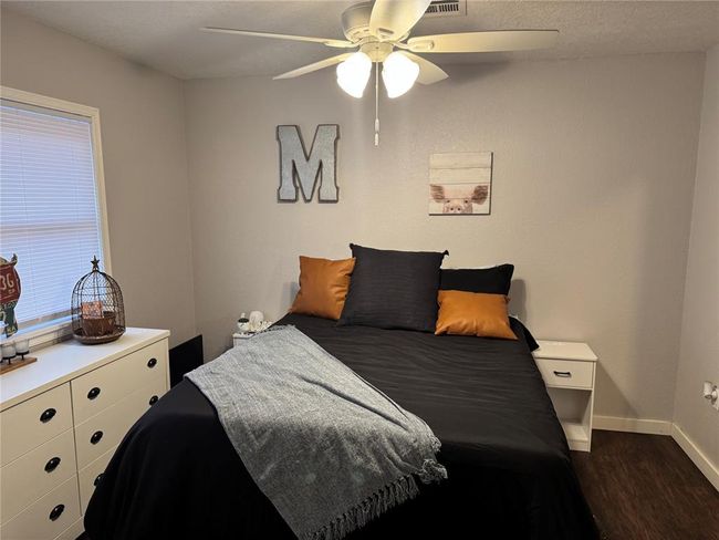 Bedroom featuring dark hardwood / wood-style floors and ceiling fan | Image 13