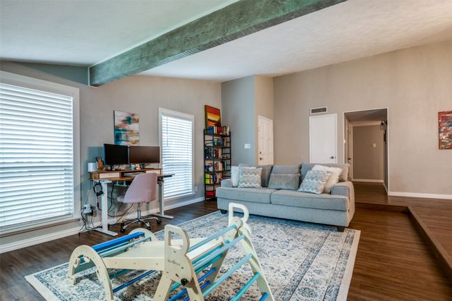 Living room with wood finished floors, and lofted ceiling with beam | Image 22