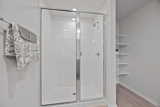 large walk in shower with additional shelving for linens and toiletries | Image 22