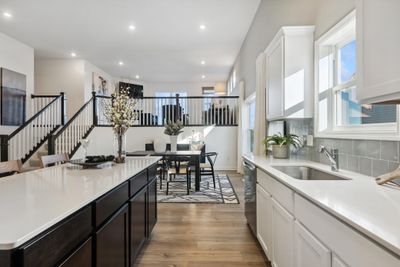 (*Photo of decorated model, actual homes colors and finishes will vary) Modern and functional, the kitchen is sure to impress. | Image 3