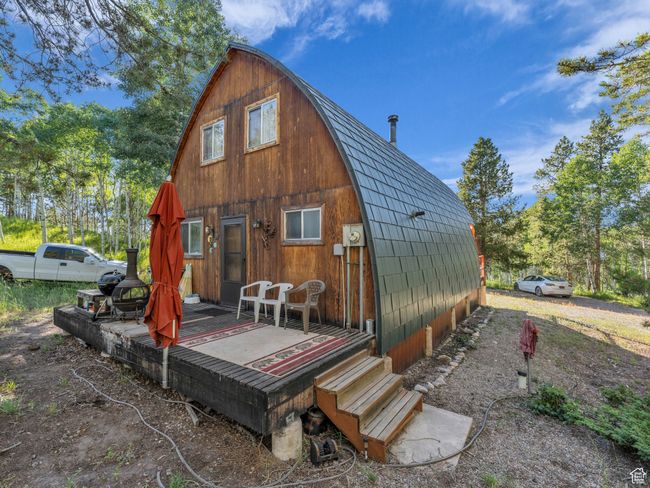 Rear view of house with a gambrel roof and a deck | Image 22