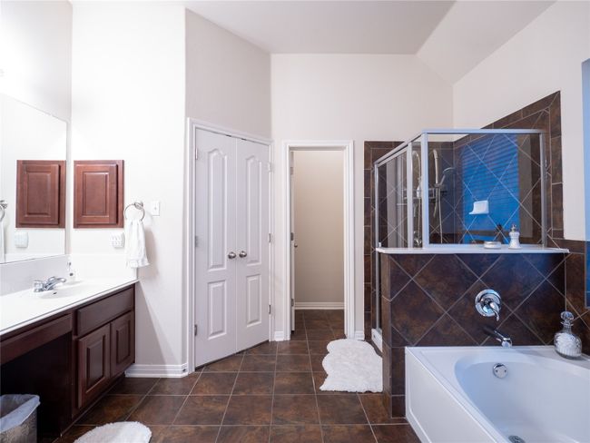 Primary bath with vaulted ceiling and walk in closet. | Image 17
