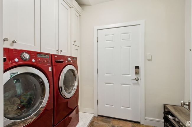 Washroom featuring washer and clothes dryer and cabinet space | Image 21