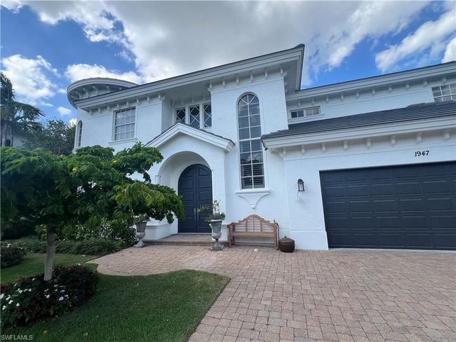 View of front facade with a garage, stucco siding, and decorative driveway | Image 38