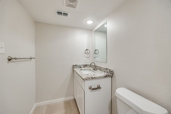 Bathroom with tile patterned floors, vanity, and toilet | Image 19