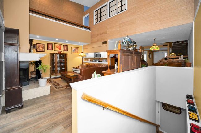 View of Living Room from indoor staircase from the Bonus Room. | Image 56