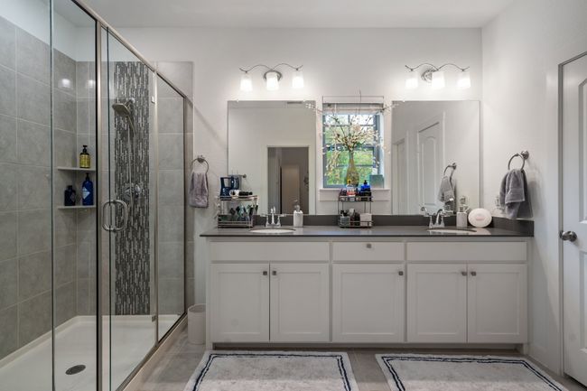 Full bathroom featuring double vanity and a stall shower | Image 17
