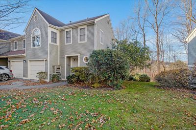 View of homes exterior featuring a lawn and a garage | Image 2