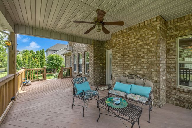 The covered deck is the perfect spot for savoring coffee, enjoying a meal, reading, or simply taking in the serene natural surroundings. | Image 41