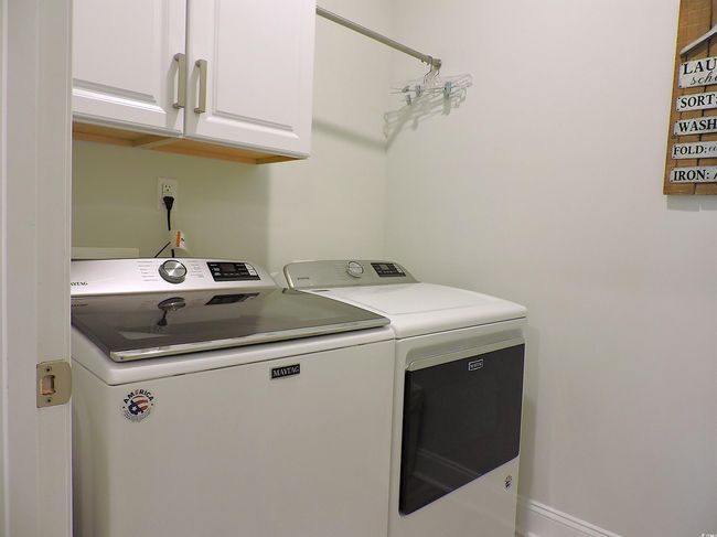 Laundry room featuring washer and clothes dryer and cabinet space | Image 30