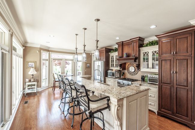The kitchen features a Thermador gas stove and dishwasher, granite countertops, custom cabinetry, and views of the Old Hickory Lake! | Image 32