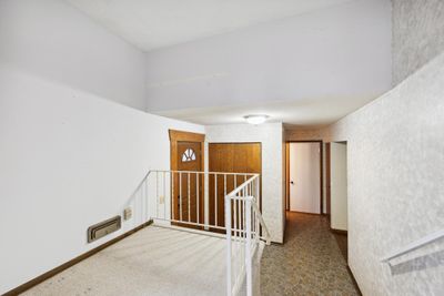 Large front entry with closet and hall to attached garage | Image 3