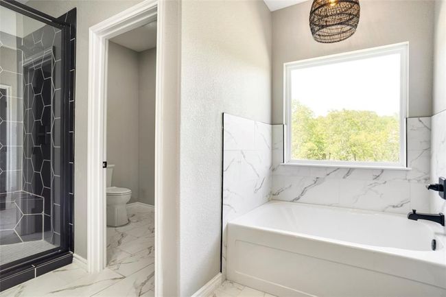 Bathroom with tile floors, independent shower and bath, and toilet | Image 25