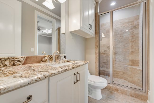 Bathroom with toilet, vanity, a shower stall, and crown molding | Image 31