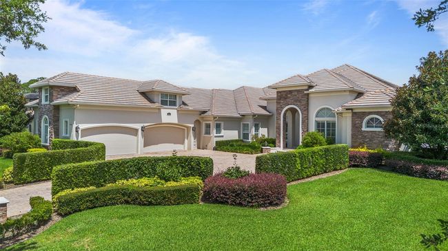 With impeccable curb appeal, a three-car garage, and grand architectural design, this custom Keene’s Pointe residence makes a commanding statement of elegance and luxury. | Image 32