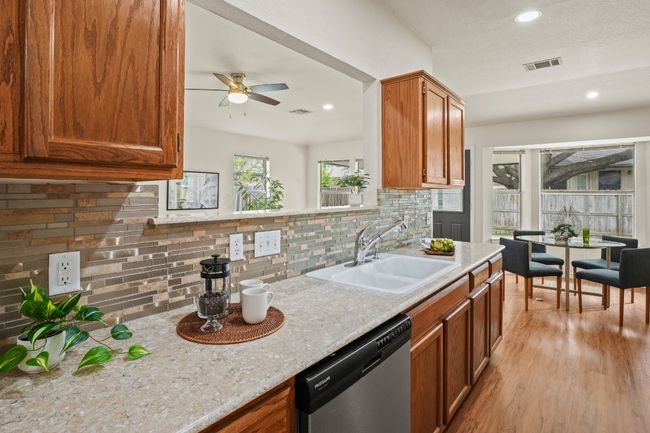 Kitchen opens to the dining area and living room for a connected feel. 9349 Bernoulli Dr., Austin, TX 78748 | Image 11