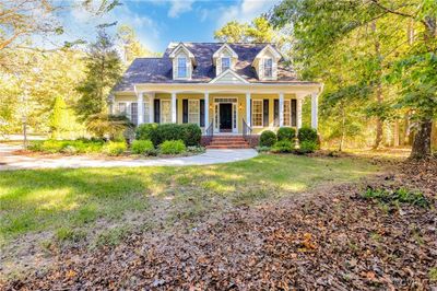 Cape cod-style house with a front yard and a porch | Image 2