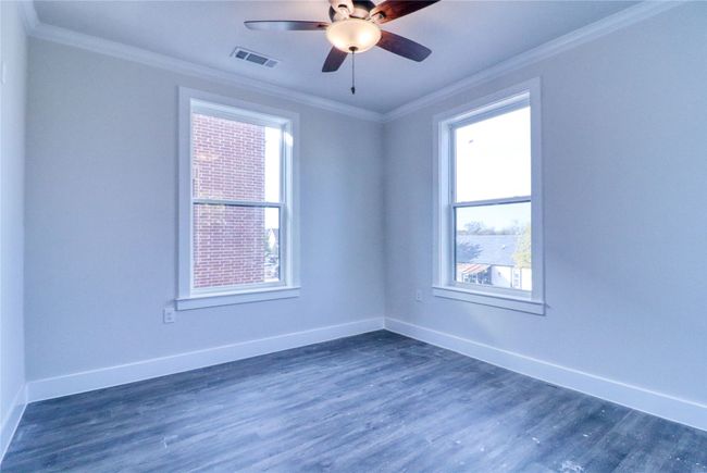 Unfurnished room with crown molding, a healthy amount of sunlight, and dark hardwood / wood-style floors | Image 11