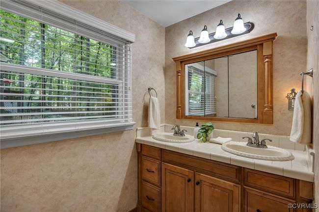 Full bathroom featuring natural light and double vanity with plenty of storage | Image 19