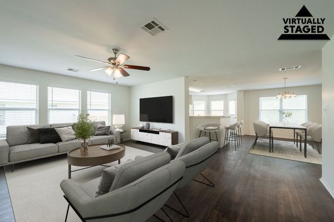 Living room featuring a chandelier, dark wood finished floors, ceiling fan, and baseboards | Image 6