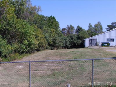 View of yard with an outbuilding | Image 2