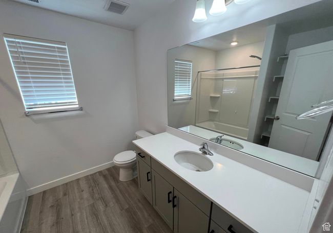 Full bathroom featuring wood finished floors, vanity, and shower / bathtub combination | Image 18