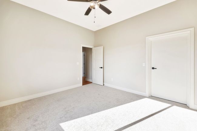 Unfurnished room featuring ceiling fan and light colored carpet | Image 32