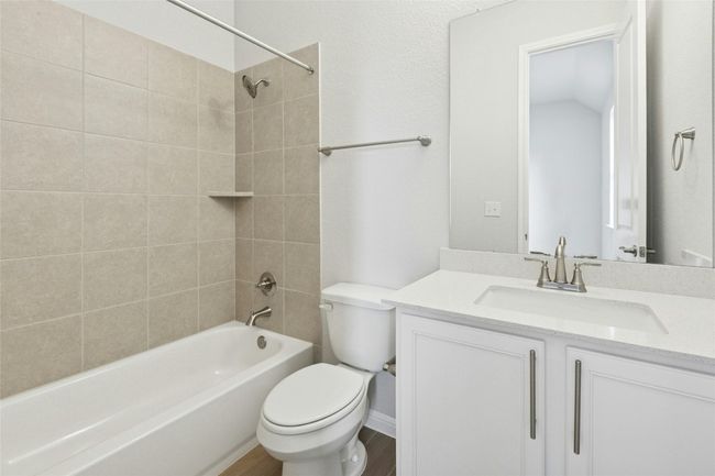 Full bathroom featuring toilet, shower combination, vanity, and wood finished floors | Image 18