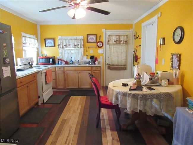 Kitchen with ceiling fan and wood flooring | Image 6