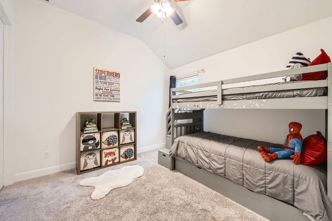 Bedroom with lofted ceiling, carpet floors, and a ceiling fan | Image 21