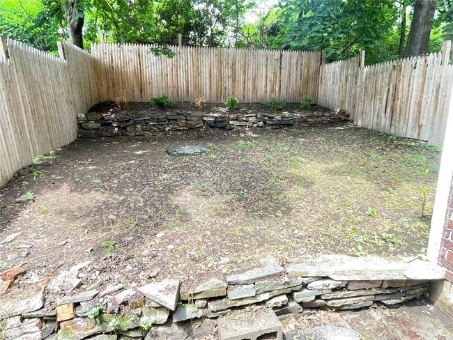 View of fenced backyard | Image 15