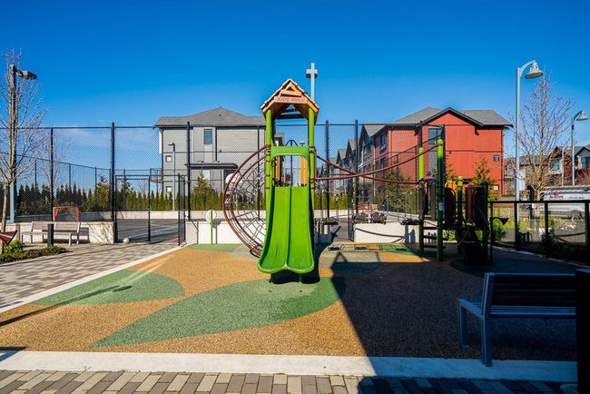 Community play area featuring a residential view and fence | Image 30