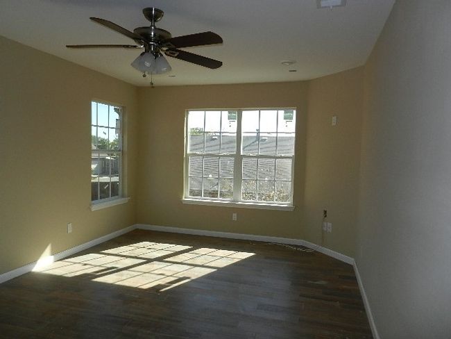 Unfurnished room featuring wood finished floors and ceiling fan | Image 14