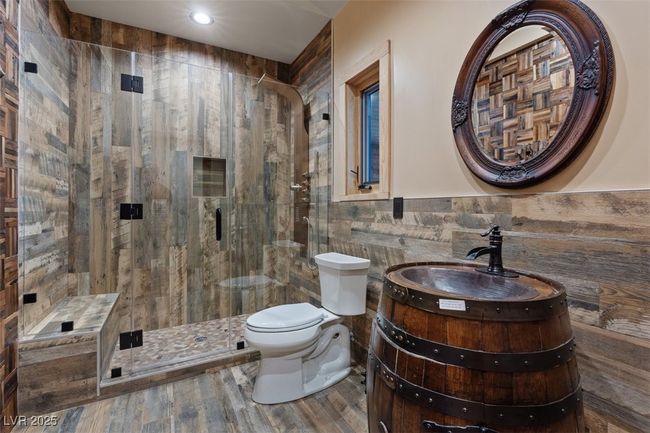 Full bathroom with toilet, vanity, tile walls, wainscoting, and a shower stall | Image 65
