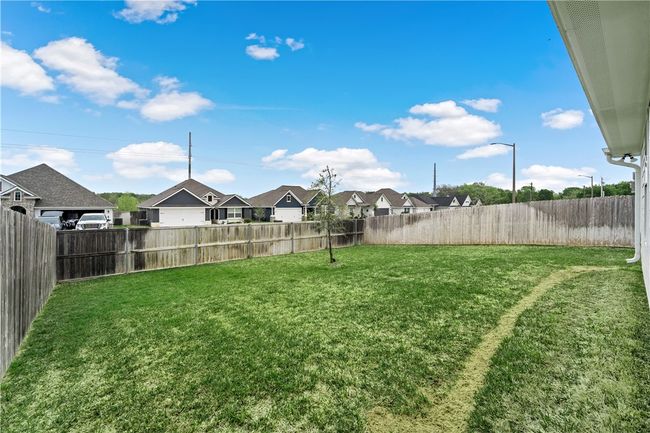View of yard featuring a fenced backyard and a residential view | Image 26