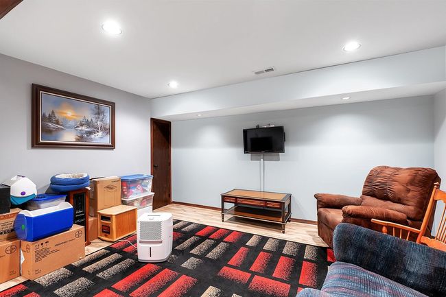 Living area with light wood-style floors and recessed lighting | Image 23