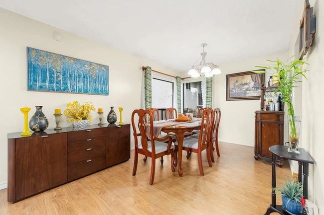 Dining area featuring baseboards, an inviting chandelier, and light wood-style flooring | Image 11