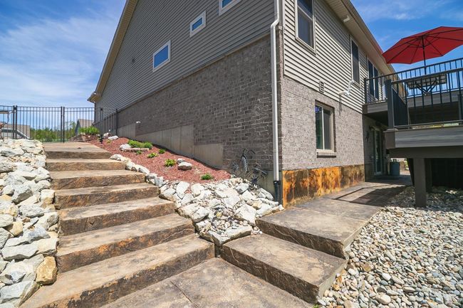 5' wide stamped, embossed walk paths lead to the patio area. | Image 46