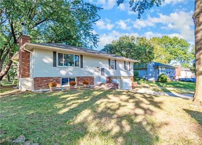 Raised ranch featuring a front yard and a garage | Image 2