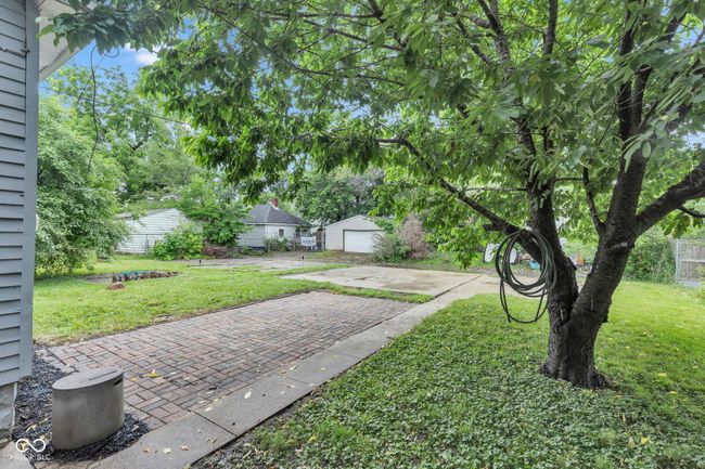 Rear lawn with entrance and driveways. | Image 48