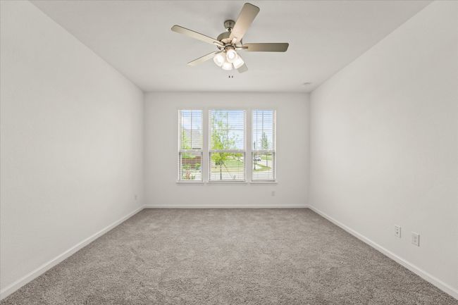 Carpeted empty room featuring baseboards and ceiling fan | Image 6