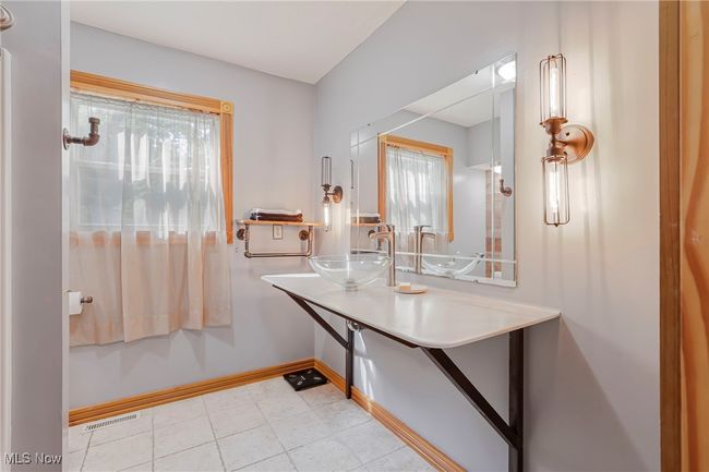 Bathroom featuring baseboards and tile patterned floors | Image 22