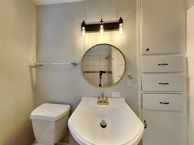Bathroom with toilet and a sink | Image 11