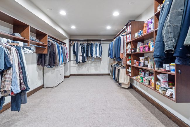 Walk in closet featuring light carpet | Image 62