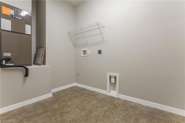 Laundry room with hookup for a washing machine, hookup for an electric dryer, and heating unit | Image 9
