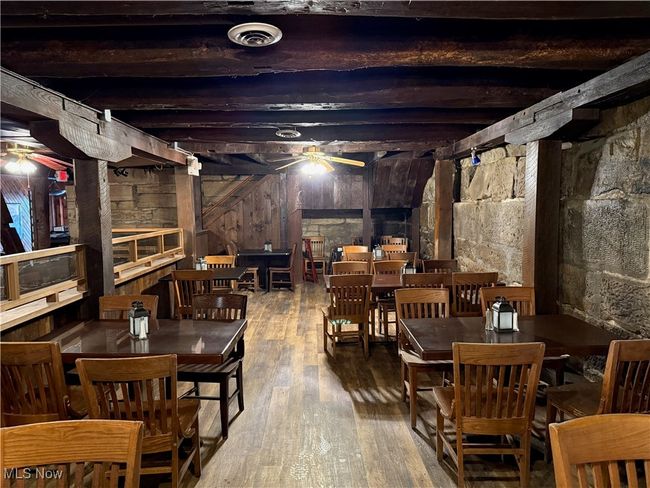 Below grade area featuring a ceiling fan, hardwood / wood-style flooring, and wooden walls | Image 26