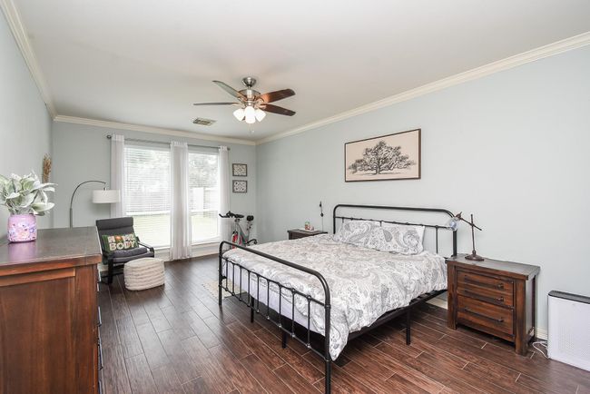 Your 13' x 21' primary bedroom has plenty of windows to let in the cheerful natural light during the day. Note that all fans in your new home have recently been updated (2022). | Image 14