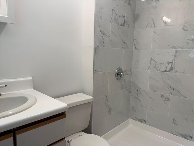 Full bath featuring tiled shower and vanity | Image 11