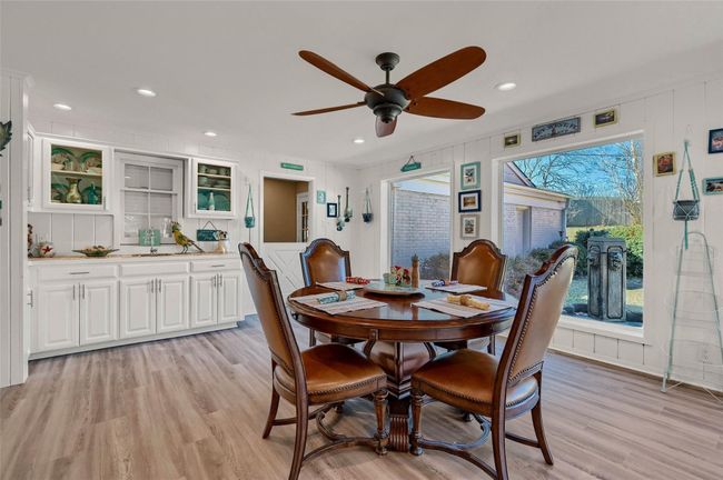 Dining room with light wood-type flooring, a ceiling fan, and recessed lighting | Image 18